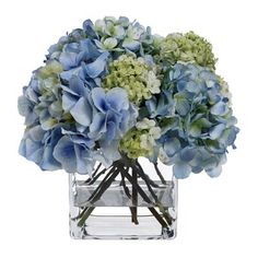 a clear vase filled with blue and green flowers