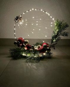 a christmas wreath with lights and ornaments on it