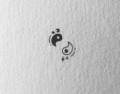 the yin symbol is drawn in black ink on white paper, with stars and circles around it