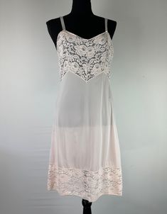 Adorable slip to wear as dress! THE DETAILS: Pale pink in color, lace bodice and hem, semi-sheer, bodice in lined, adjustable straps, tapers through waist ~ Era: 90's/Y2K ~ Material: Nylon ~ Condition: Good, no flaws - ready to wear MEASUREMENTS (Flat Lay): ~ Chest/Pit to Pit 18" ~ Hip 18" ~ Length 32" *COMPARE PERSONAL MEASUREMENTS FOR PROPER FIT - Ships quickly - Message with any questions - Shop with confidence -  Perfectly imperfect vintage charm may exist, but that's the sustainability appe Fitted Pink Lace Camisole, Fitted Lace Pink Camisole, Sheer Sleeveless Coquette Slip Dress, Pink Sheer Slip Dress, Coquette Lace Slip Dress With Delicate Details, Sheer Pink Slip Dress, Sleeveless Pink Dress With Contrast Lace, Pink Sleeveless Dress With Contrast Lace, Pink Lace Trim Camisole With Spaghetti Straps