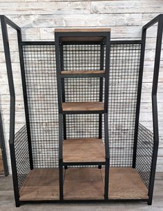 an industrial shelving unit with four shelves and metal mesh dividers on the sides