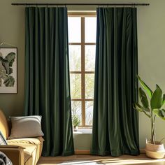 a living room with green drapes and a plant in the corner by the window