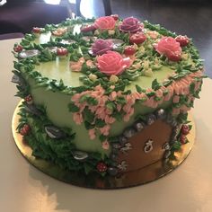 a cake decorated with flowers and leaves on a table