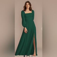 a woman in a long green dress posing for the camera