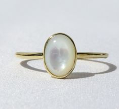 Elegant, simple and truly a classic piece. This mother of pearl ring is made from 14k solid gold or 14k solid white gold material. Set with a natural mother of pearl stone. Each pearl is unique and natural. Whether you're buying this beautiful pearl ring as a gift or for yourself, it will bring forth new beginnings and good luck. Handmade in Los Angeles, CA! Fast Shipping: It will take 1-3 business days to send out your item Packaging: Comes in an upgraded gift box, ready for gift-giving! Pearl Polished Mother Of Pearl Wedding Rings, Classic White Opal Ring With Polished Finish, 14k Gold Polished Moonstone Wedding Ring, 14k Gold Moonstone Ring For Wedding, 14k Gold Moonstone Ring With Polished Finish For Wedding, Timeless Yellow Gold Moonstone Ring, Classic White Signet Ring With Round Band, Classic White Signet Ring, White Sterling Silver Pearl Ring With Polished Finish