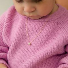 You can never go wrong with styling up your little girls favorite outfits with this tiny yet elegant pendant. This beautiful halo pendant features a stunning 4mm clear cubic zirconia stone at its center. This beautiful pendant is perfect to pair with a thin matching 14k Gold chain. This lovely pendant arrives packaged into a gift box for easy gifting. Age Group: Beautiful for Little Girls & Preteens; Safe for Sensitive Skin Material: 14k Yellow Gold Pendant Size: 6mm W x 6mm H Chain Length: 12"- Kids Chain Designs Gold, Kids Gold Chain Designs, Baby Chain Designs Gold, Gold Chain For Baby Girl, Baby Gold Chain Designs, Kids Necklace Gold, Kids Gold Jewellery, Baby Jewelry Gold, Toddler Necklace