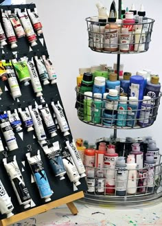 a rack with lots of different types of paint and glues on top of it