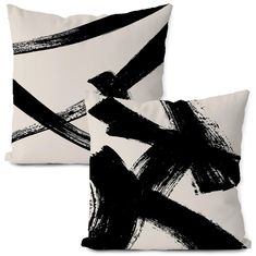 two black and white pillows sitting next to each other