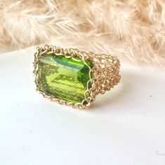 14k Gold Peridot Ring:    ♥ Gemstone Type - Peridot (Lab Created) ♥ Gemstone Size - 13x18mm ♥ Gemstone Cut - Rectangle ♥ Metal Type - 14k Gold Filled - (Other options available in the drop-down menu) ♥ Tarnish Resistant This Fine 14k Gold Peridot Ring is sure to grab compliments, dress up your casual outfit with a remarkable large stone ring, Gold Statement Ring made of 14k Gold-filled wire crochet statement band with Precious Stone - Peridot Rectangle.  This Green Stone ring will make any woman Fine Jewelry Green Rings With Rectangular Stone, Handmade Elegant Peridot Rings, Unique Green Rectangular Jewelry, Gold Rectangular Rings With Accent Stones, Rectangular Gold Rings With Accent Stones, Elegant Peridot Crystal Ring As A Gift, Elegant Peridot Crystal Ring Gift, Elegant Handmade Peridot Rings, Handmade Elegant Green Birthstone Ring