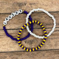 Looking for a fun way to show support for your home sports team, kid's sports teams or teams you root for? Well these bracelet trios are for YOU! Please be EXTREMELY detailed in your description in the personalization box! If you are wanting the team name to be on a specific color, let us know that! Also, let us know what the dominant colors are vs lesser colors. If we have any questions, we will reach out!  This listing is for a set of three colored beaded bracelets. One solid color with the team name and two other bracelets (1 solid, 1 alternating). Bracelets come in sizes 6"-8". If you are needing a more personalized size, please reach out to us! We use high quality 6mm Czech glass beads. We make sure to only string good, perfect beads for our bracelets. Beware as some vendors offer low Team-colored Sports Bracelets With Letter Beads, Team-colored Bracelets With Letter Beads For Sports, Team-colored Letter Beads Bracelets For Sports, Adjustable Team-colored Beaded Bracelets, Team Spirit Letter Beads Wristband For Game Day, Team Spirit Wristband With Letter Beads For Game Day, Team-colored Wristband For Game Day, Sporty Beaded Bracelets In Team Colors For Sports Events, Sporty Team-colored Beaded Bracelets For Sports Events