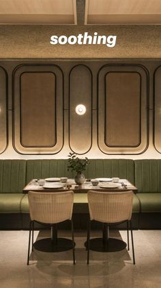 an empty restaurant with green booths and white tablecloths on the tables in front of them