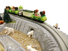 a lego train with polar bears and people on it