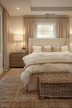 a bedroom with a large bed and wicker baskets on the floor in front of it