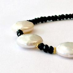 This black white bracelet created by Jewelry by CARMAL is made of: white disk shaped freshwater pearls, black spinel gemstones, gold filled: spacers, toggle and findings. This bracelet measures 7 1/2 inches in length. This bracelet goes great with the earrings in this listing: http://www.etsy.com/listing/95636406/freshwater-pearl-earrings-black-spinel View more beaded bracelets: http://www.etsy.com/shop/jewelrybycarmal?section_id=8002918 All of our jewelry comes wrapped and ready for gift giving Elegant Rondelle Pearl Bracelet With Gemstone Beads, Elegant Handmade Black Pearl Bracelet, Elegant Rondelle Faceted Pearl Bracelet, Elegant White Bracelets With Black Beads, Elegant White Bracelet With Black Beads, Elegant Round Pearl Bracelet With Faceted Beads, Elegant White Pearl Bracelet With Faceted Beads, White Bracelet, Spinel Gemstone