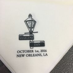 a close up of a white handkerchief with a street light on it and the words sharlene dan written in black