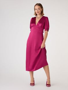 Odette is elegance with an edge. The 3/4 length sleeves are gathered at the bottom to create a feminine silhouette offset with a deep v-neckline. With an open back with sash detail, this dress in deep magenta recycled satin is a date night dream. Feminine Midi Dress With Surplice Neckline For Evening, Chic Midi Dress With 3/4 Sleeve For Party, Magenta Fall Dress, Feminine V-neck Dinner Dress, Chic V-neck Satin Dress For Brunch, Satin V-neck Midi Dress For Brunch, Chic Midi Dress With 3/4 Sleeves For Date Night, Feminine V-neck Satin Dress For Night Out, Satin V-neck Midi Dress For Party