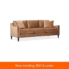 a brown couch with pillows on it and the words now trending $ 50 & under