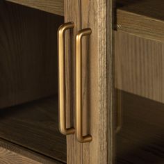 a close up view of the handles on a wooden cabinet