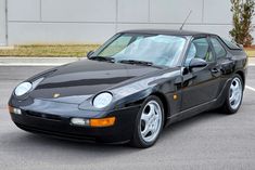 a black sports car parked in a parking lot