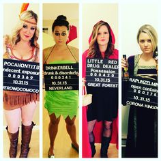 three women dressed in costumes holding up signs