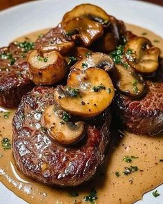 steak with mushrooms and gravy on a white plate