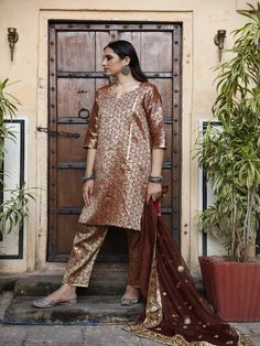 With festivals around the corner, wardrobe update is mandatory. Presenting brocades like never before. Made in straight silhouette with narrow pants and organza dupatta, which is beautified with lovely hand work. Taari and gotta detailing on dupatta is just the right touch. Color: Brown Fabric: Kurta & Bottom- Brocade Dupatta - Organza Note: Length and sizes can be customised Length - Kurta 40 inches Pants 38 inches Available in other colors If you happen to see some deformity in hand-work or fa Festive Tissue Silk Churidar With Straight Kurta, Traditional Palazzo Set With Sheer Dupatta For Celebration, Celebration Palazzo Set With Sheer Dupatta, Festive Straight Kurta Churidar In Tissue Silk, Festive Chikankari Embroidery Palazzo Set In Art Silk, Semi-stitched Brocade Palazzo Set, Festive Chikankari Embroidery Art Silk Palazzo Set, Elegant Brocade Palazzo Set With Straight Kurta, Festive Palazzo Set With Sheer Dupatta For Celebration