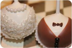 two cake pops decorated with pearls and bow ties