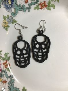 Skull embroidered Halloween earrings crafted with vibrant embroidery thread to make a stunning addition to any outfit, adding a frightening touch. These earrings are super lightweight, unique, and make a wonderful gift for any scary occasion. The hypoallergenic French ear wire hooks and jump rings are made from stainless steel and include clear silicone earring backs. The earrings are stitched with an embroidery machine using a technique called Free Standing Lace (FSL). There are several colors Adjustable Black Skull-shaped Earrings, Adjustable Black Skull Earrings, Novelty Black Skull Earrings, Handmade Black Skull Earrings, Thanksgiving Earrings, Tatted Earrings, Free Standing Lace, Lace Earrings, Embroidered Towels