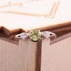 "Simple & dainty 14k rose gold peridot promise ring for her, Elegant 3 stone womens promise ring, Gold 3 stone peridot engagement ring WE OFFER UNLIMITED PERIOD INSTALLMENTS PLAN This is a beautiful, stunning, feminine ring that works well for all occasions, styles, and ages. You will love it! Ring information Main stone: Peridot Approximate size: 4.5mm Accent stone: Cubic zirconia Approximate size: 3mm Metal type: Gold Metal stamp: 14k solid gold Customization / Replacements It's easy to cr Rose Gold Three Stone Jewelry, Rose Gold Cubic Zirconia Three Stone Jewelry, Rose Gold Three Stone Cubic Zirconia Jewelry, Rose Gold Three Stone Jewelry As A Gift, Rose Gold Three Stone Jewelry For Anniversary, Rose Gold Three Stone Jewelry For Gift, Rose Gold Three Stone Jewelry Gift, Fine Jewelry In Rose Gold With Three Stones, Fine Jewelry With Round Cut Peridot