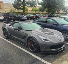 there are many cars that are parked in the parking lot, and one is gray