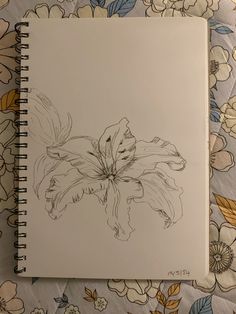 a notebook with a drawing of flowers on it