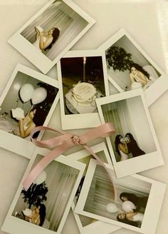 several polaroid photos with pink ribbon and balloons in the background on a white surface