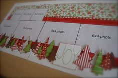 a christmas tree themed calendar is displayed on a table with red and green ribbon around it