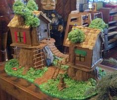 a cake made to look like a house with trees on the roof and stairs leading up to it