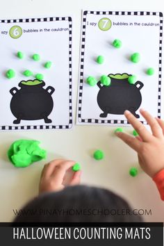 two children playing with halloween counting mats