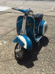 a blue and white scooter parked on the street