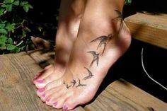 a woman's foot with birds on it