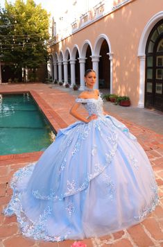 Elegant quinceañera ball gown with off-the-shoulder bell sleeves adorned with three-dimensional flower and beading details, detachable cape, embroidered lace, stone accents and a back bow. Ballgown Design, Quinceanera Collection, Cape Sleeve Dress, Fringe Cape, Beaded Cape, Debutante Ball, Quinceanera Dresses Blue, Quince Dress, Quinceanera Dress