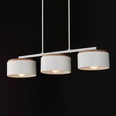 three lights hanging from the ceiling in a room