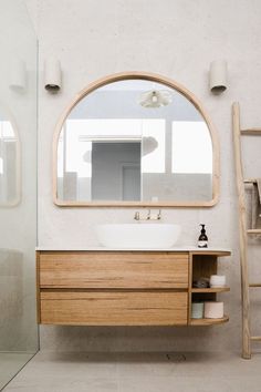 a bathroom sink sitting under a large mirror