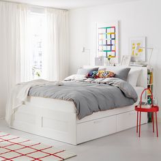 a bedroom with white walls and flooring is shown