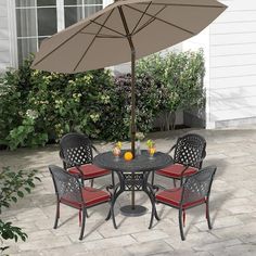 an outdoor table with four chairs and an umbrella