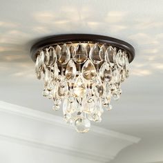 a chandelier hanging from the ceiling in a room with white walls and ceilings