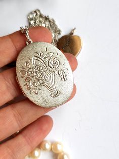 A wonderful very big silver Locket with scrolling foliage details. Very beautiful  Metall -    silver 835 Measurements  pendant  -   Length  5.  cm 1.96.  inches  necklace  60 cm   or 23.62 inches Weight  with chain          - 17.60   gramm Excellent vintage condition. Don't forget visit my collection  https://myoldvintage.etsy.com PLEASE VIEW ALL PHOTOS AND VIDEO AS THEY ARE A PART OF THE DESCRIPTION Please note that you should expect some wear with all antique and vintage pieces, it is part of their history and their charm. If you have any further questions or you need some help with something, please get in touch with us. We will be happy to help you. The other jewels on the last page you can find in my other auction. please visit Instagram my name is - MyOldVintage - Please feel free t Large Locket, Gift For Love, Silver Locket, Love Photo, Photo Pendant, Silver Lockets, Vintage Pieces, Locket Necklace, Necklace Gift