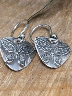 These are adorable Fine Silver Earrings with an adorable butterfly at the center.  they hang on Sterling Silver Ear wires. Silver Butterfly Earrings, Silver Butterfly, Butterfly Earrings, Fine Silver, Ear Wires, Jewelry Earrings Dangle, Silver Earrings, Etsy Earrings, Dangle Drop Earrings