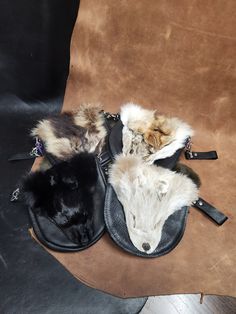 A perfect accompaniment to your festival attire, these small bags are made of soft and supple cow leather and finished with various fur faces. All bags come with two straps that can accommodate a belt up to 2" wide, as well as an adjustable shoulder strap. These straps can be easily interchanged with the attached hooks. Standard bags measure about 8.5" wide by 7.5" long. There is a snap under the face on the flap for extra security of your belongings. Pictures are examples only and faces may have variation in color, size, and shape. Please message me if you are looking for something specific. More varieties of bags are also available in black and colored bases in other listings. More options available at rabidllamacreations.com Fur Projects, Fur Belt, Fur Bags, Festival Attire, Sewing Things, Fur Accessories, Fur Bag, Black Leather Bags, Leather Bags