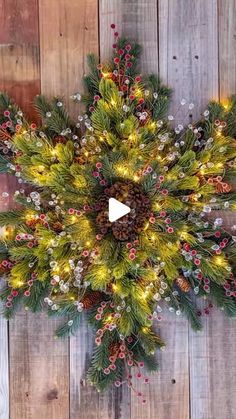 a christmas wreath with lights and pine cones