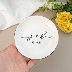 a person holding a plate with the names of their wedding date