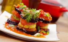 a white plate topped with food on top of a wooden table