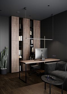 a computer desk with a laptop on top of it in front of a bookshelf